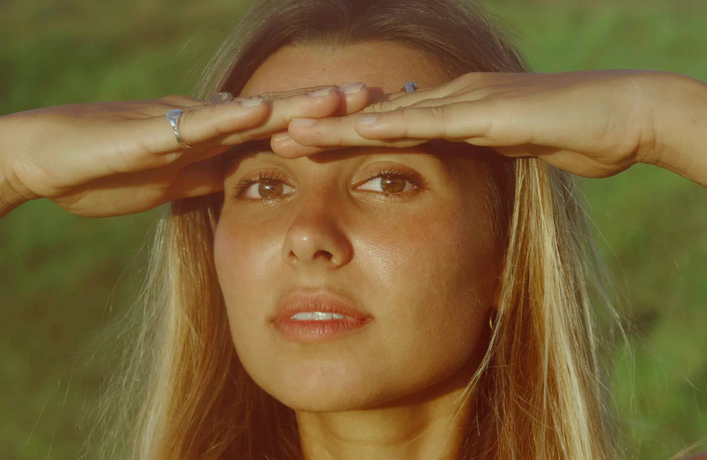 Ari shading her eyes from the sun