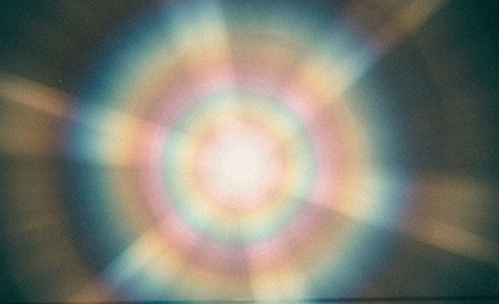 Blurred aura gradient in soft teal, blush and gold