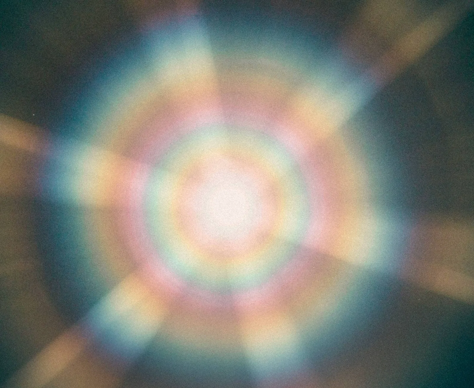 Soft iridescent aura gradient behind The Aura Code™ logo