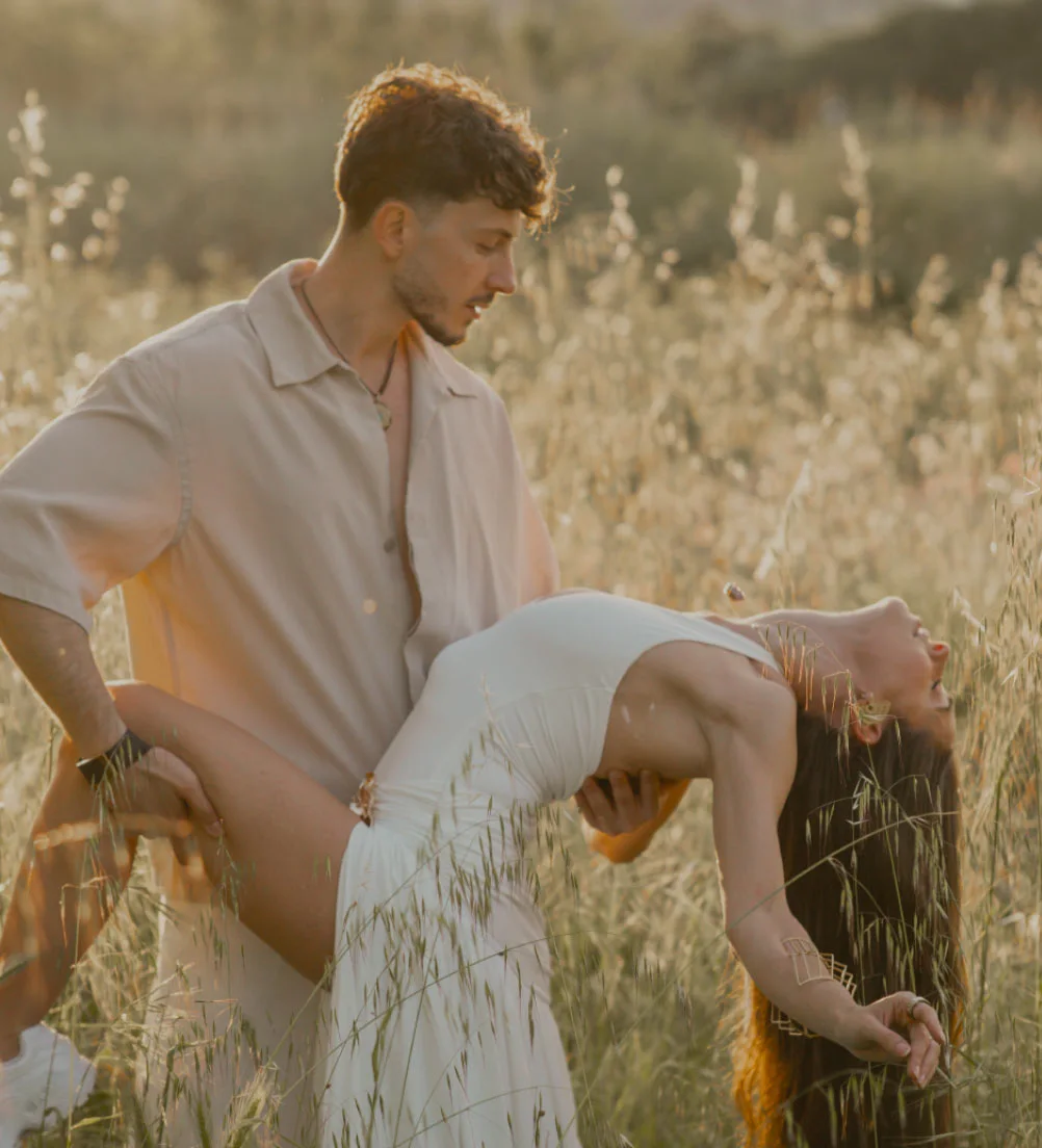 Michael & Mayra dancing in a golden field