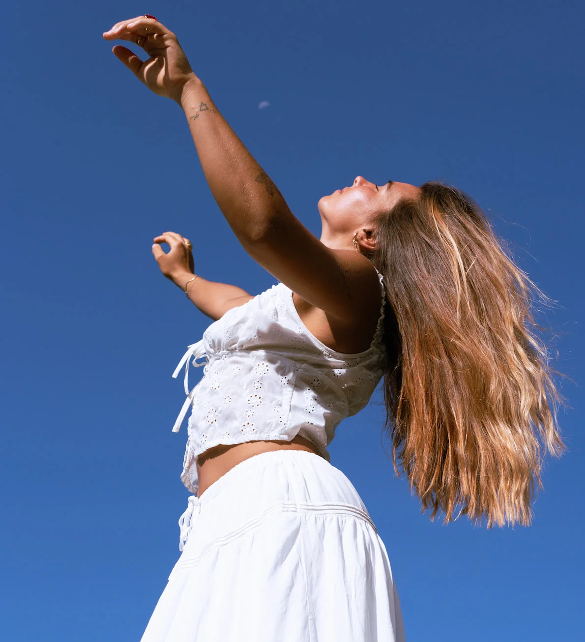 Ari reaching toward a deep blue sky, Sacred Creator™ by Ari Saso