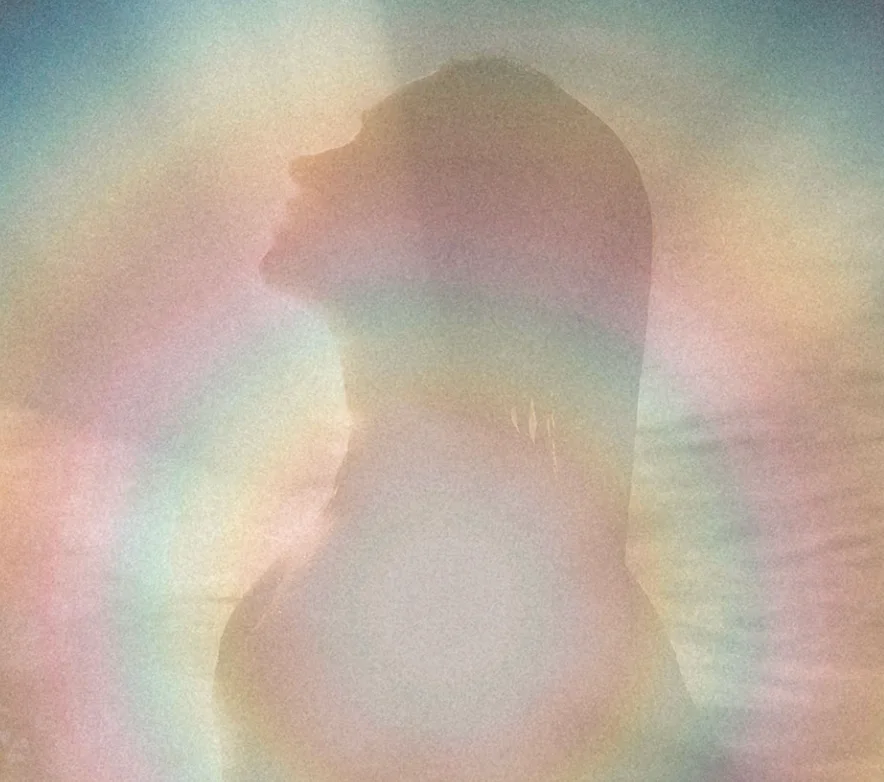 Silhouette of Ari inside a soft iridescent aura, The Aura Code™